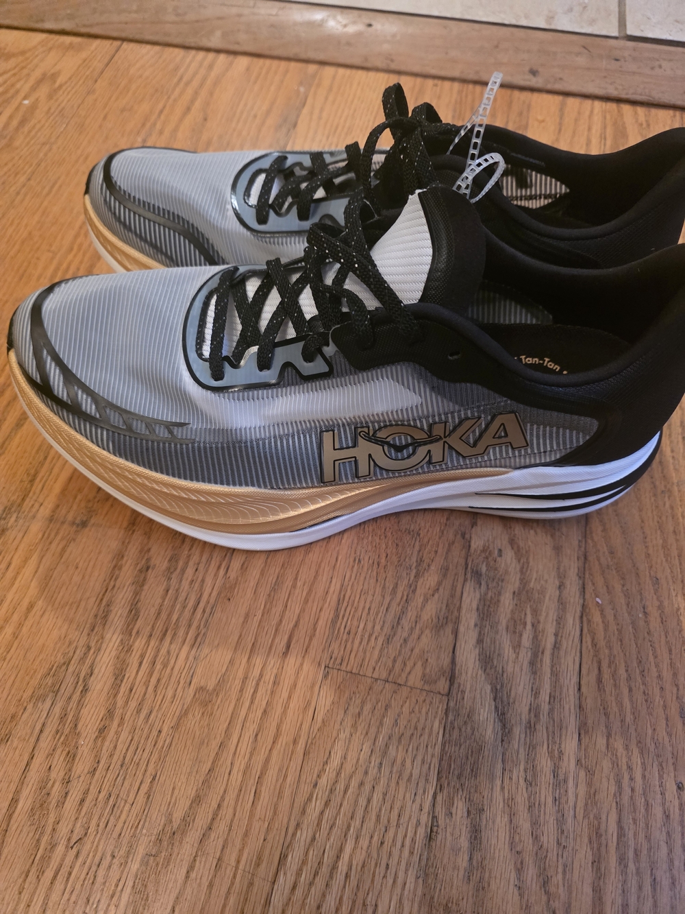 Hoka Gray and Black Running Sneakers with Gold Trim